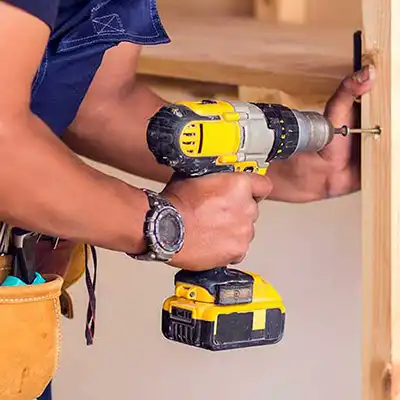 Application for handyman being used on site with man using power drill