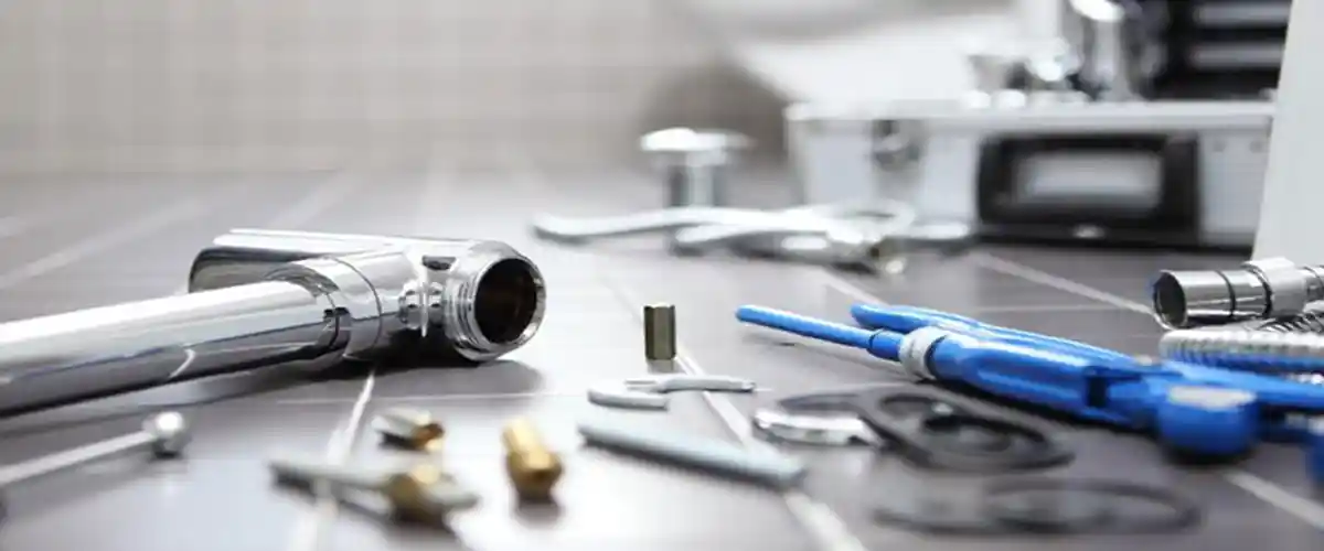 Background image of plumbing components on the floor