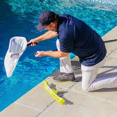 Work learning how to start a Pool Cleaning Business using skimmer