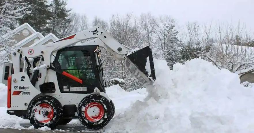 Bobcat Removing Snow in Residential Community