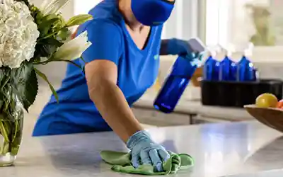 Cleaning a countertop when learning how to start a cleaning business