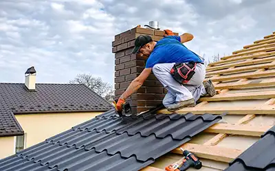 Worker using Roofing Software while installing clay shingles