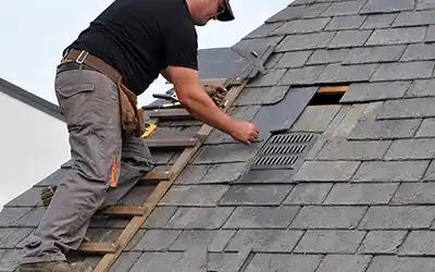 Roofer installing slate shingles using Roofing Contractor Software