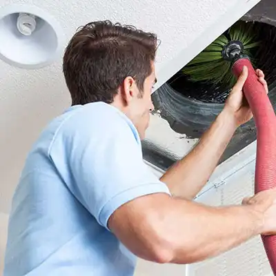 Man in ceiling using Air Duct Cleaning Software