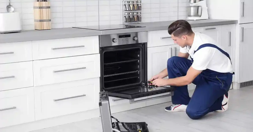 Repair Technician Fixing an Oven